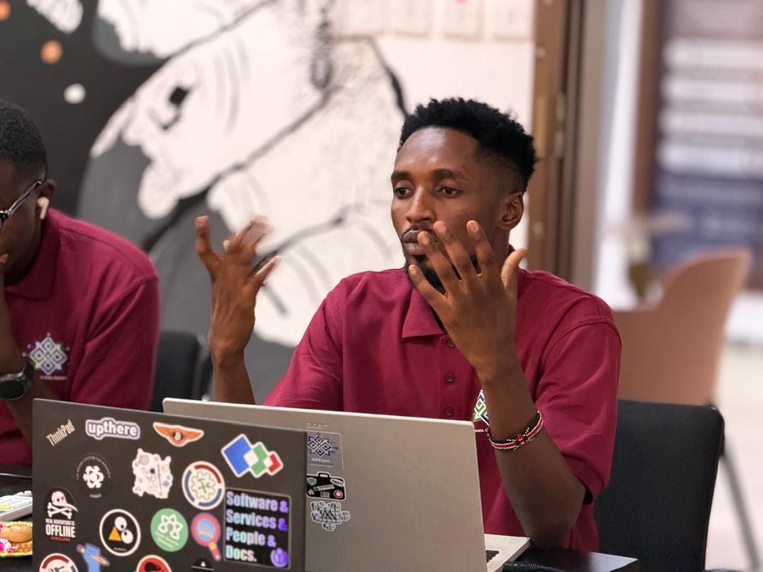 Developers working on laptops at desks during a hackathon
