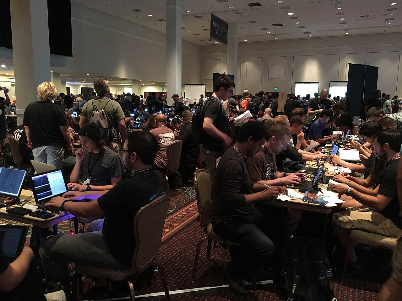 Attendees working at laptops in the contest area of the DEF CON security conference