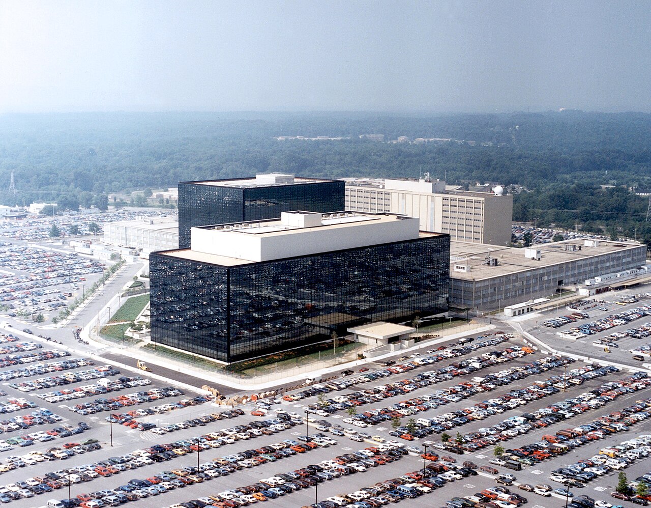 Aerial photograph of the National Security Agency headquarters building and its surrounding parking lots at Fort Meade, Maryland