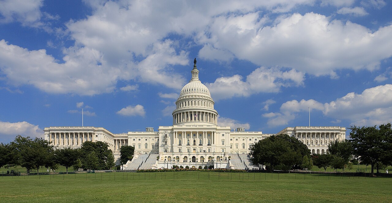 The west front of the United States Capitol under a blue sky