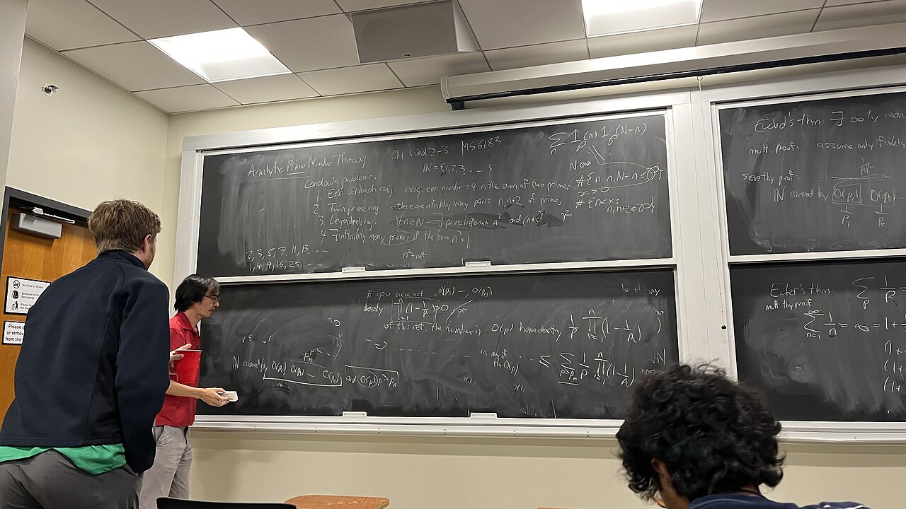 Terence Tao teaching analytic prime number theory at a classroom blackboard in January 2025