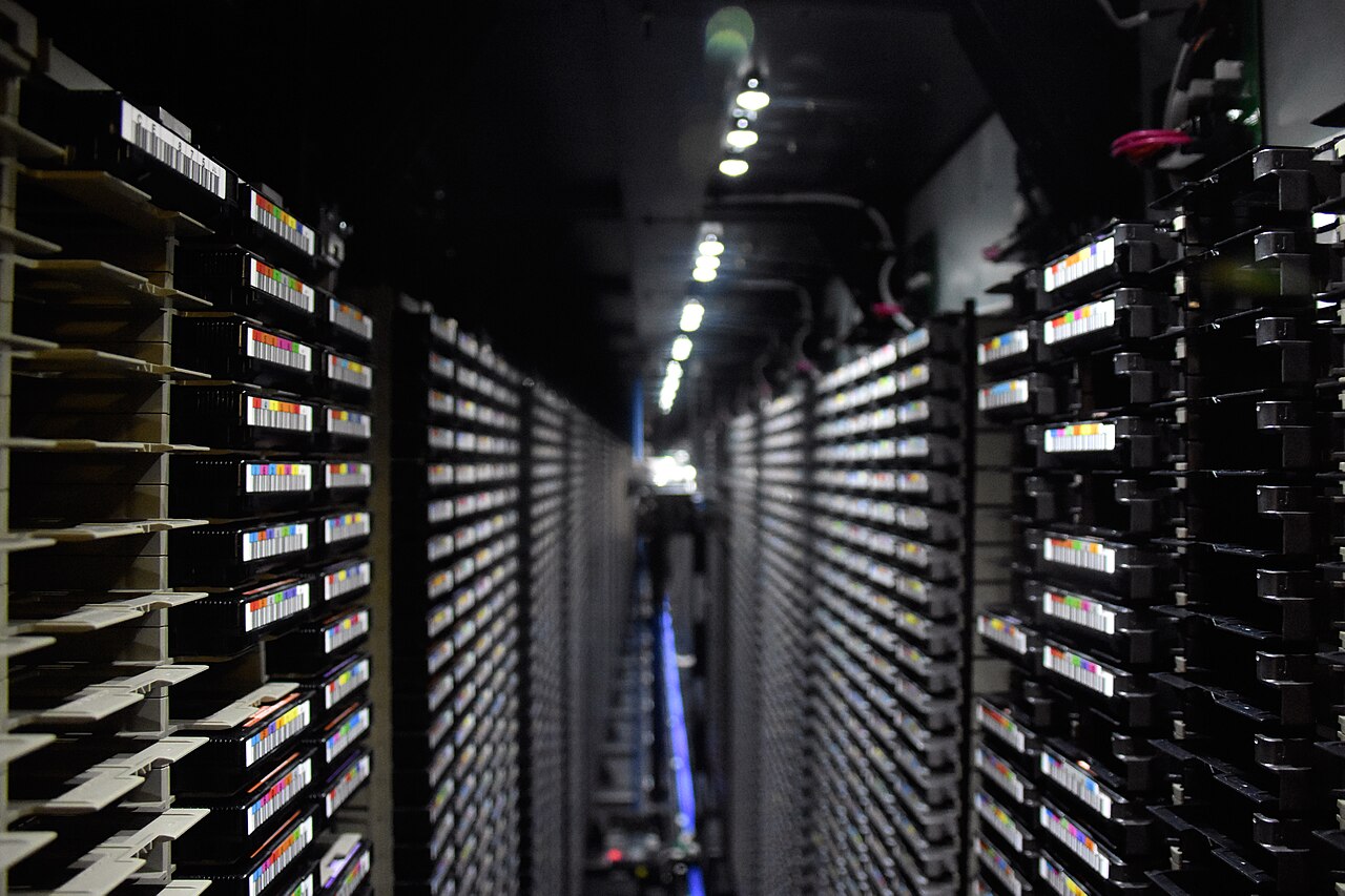 Dense rows of server and storage racks inside a large computer center