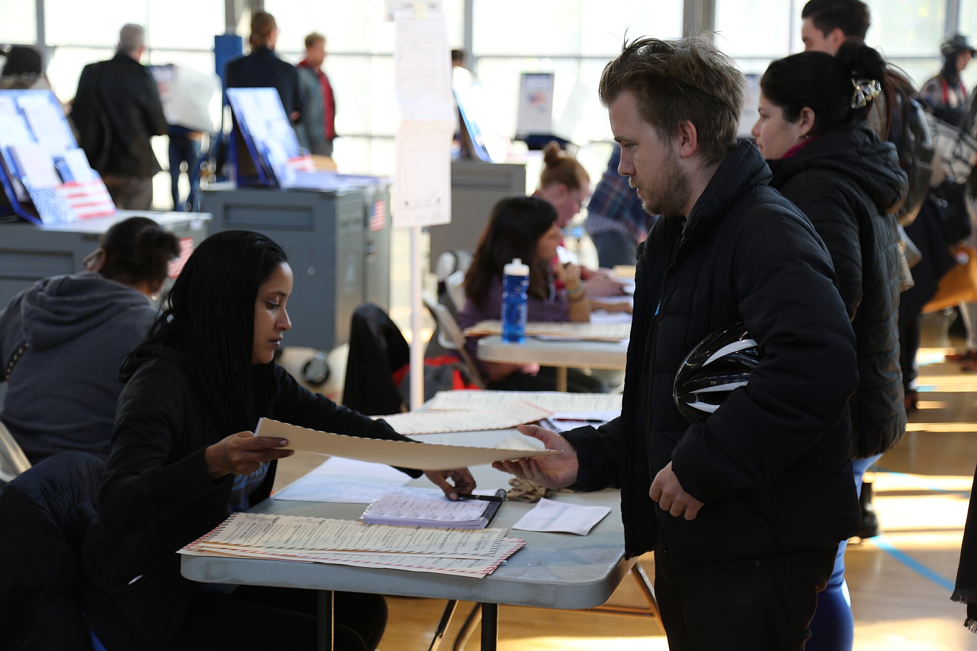 A poll worker hands a voter a ballot at a polling station in New York City