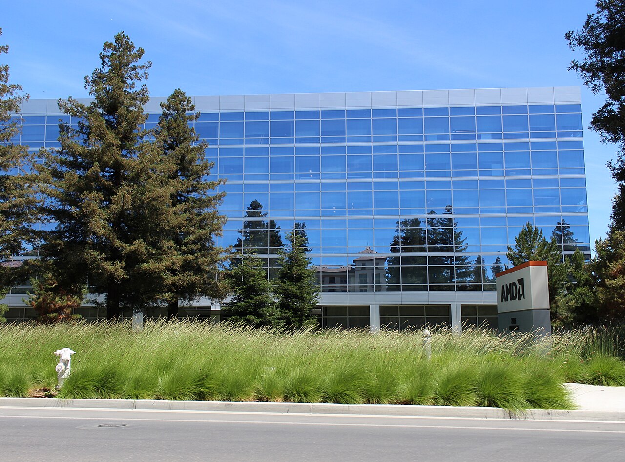 AMD's former corporate headquarters office building in Santa Clara, California, with an AMD sign visible at the entrance