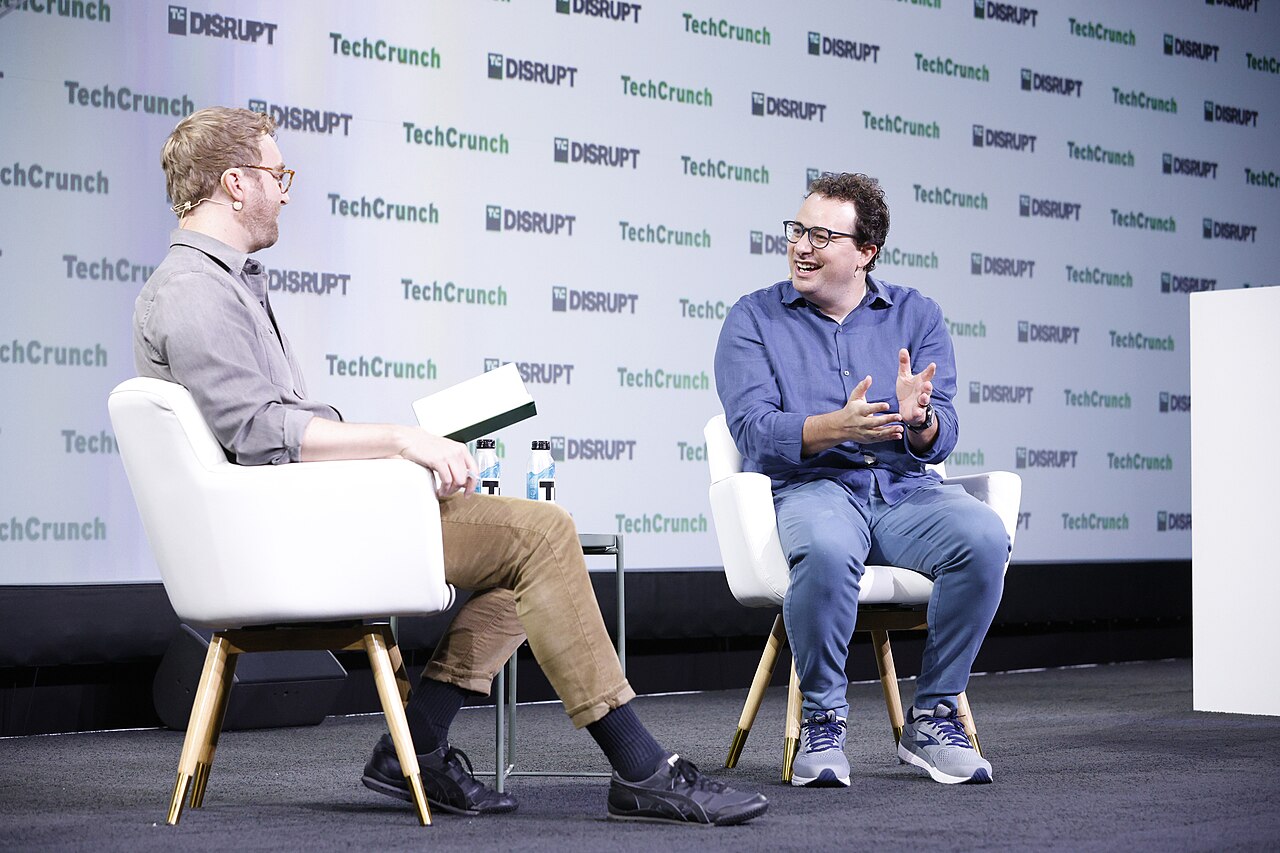 Dario Amodei, CEO of Anthropic, seated on stage at TechCrunch Disrupt during an interview