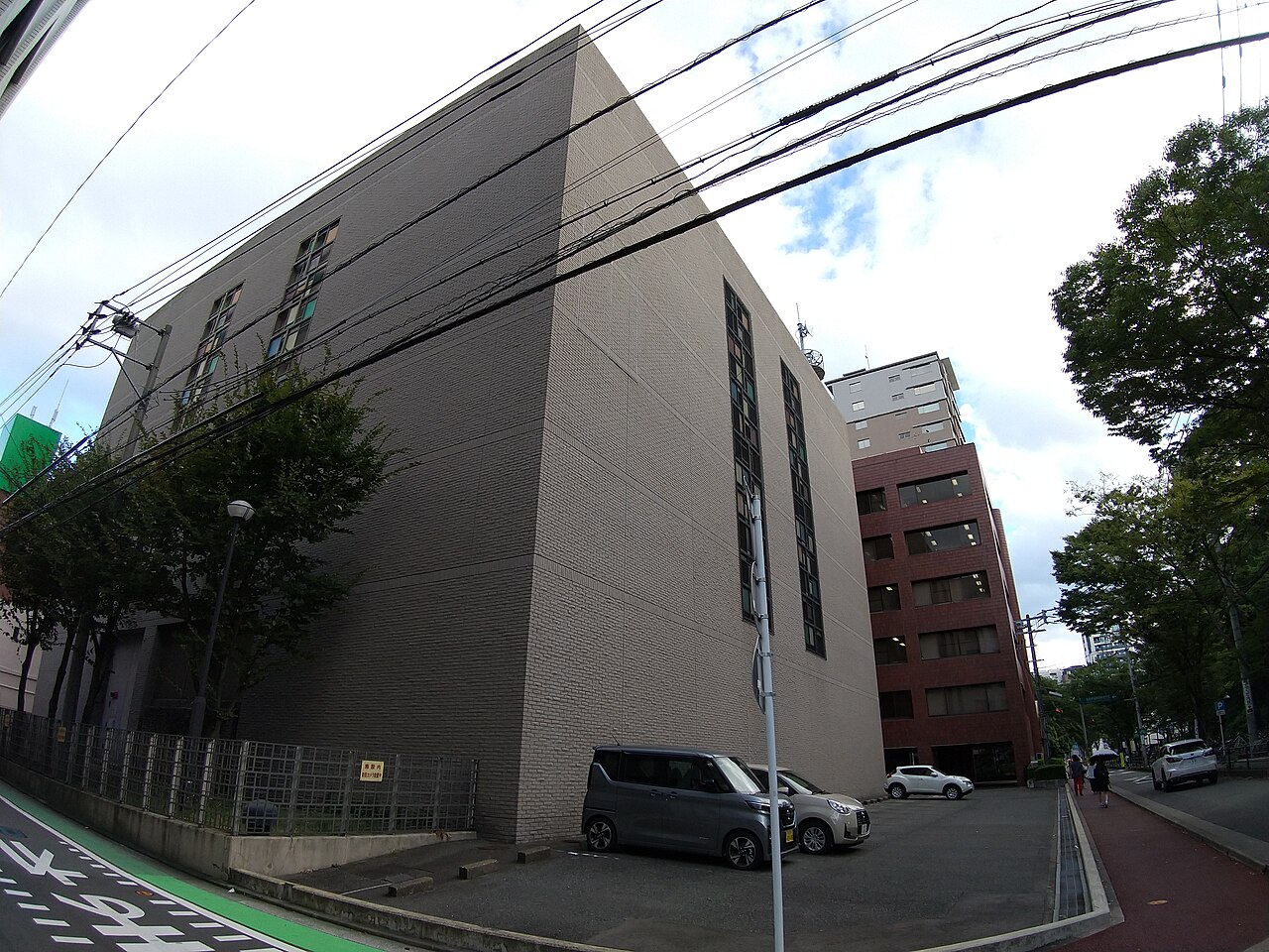 An urban electrical substation with transformers and overhead power lines