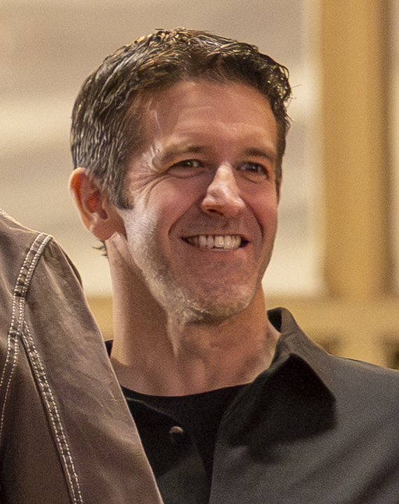 John Ternus, Apple's senior vice president of hardware engineering, smiling at a company event