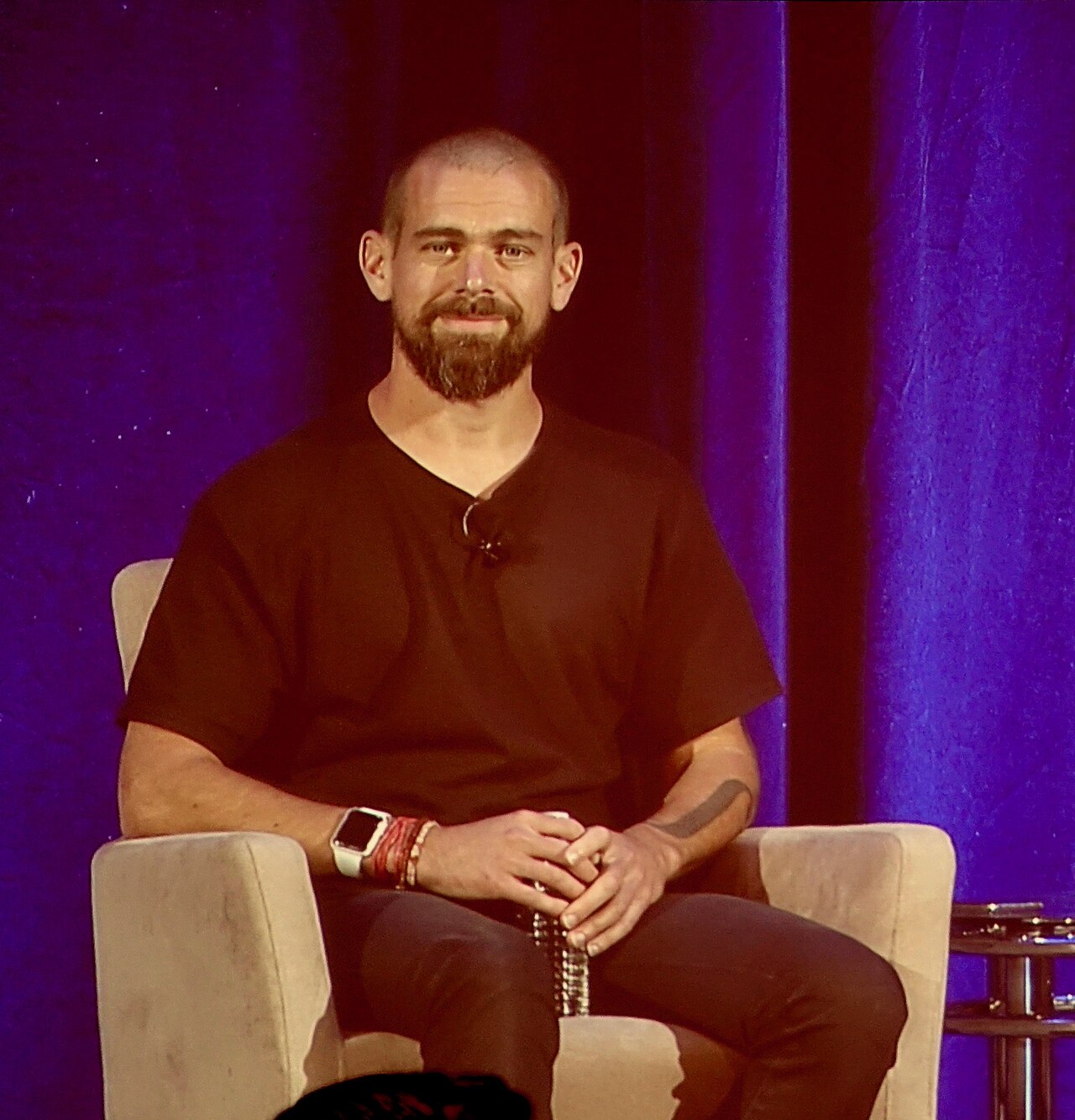 Jack Dorsey seated on stage during a fireside chat at the Goldman Sachs Technology Conference in February 2018