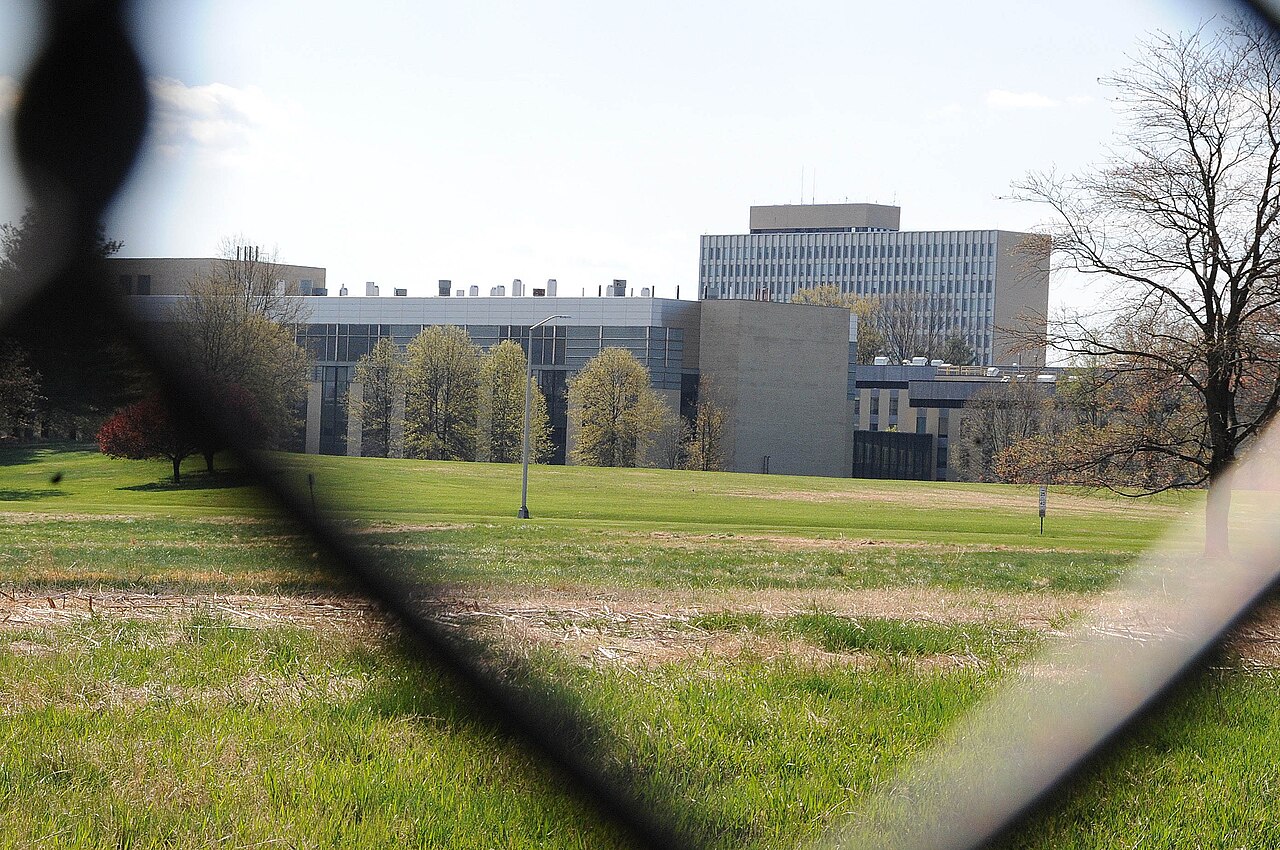 The NIST Historic District research buildings on the Gaithersburg, Maryland campus, seen across the lawn from outside the perimeter fence