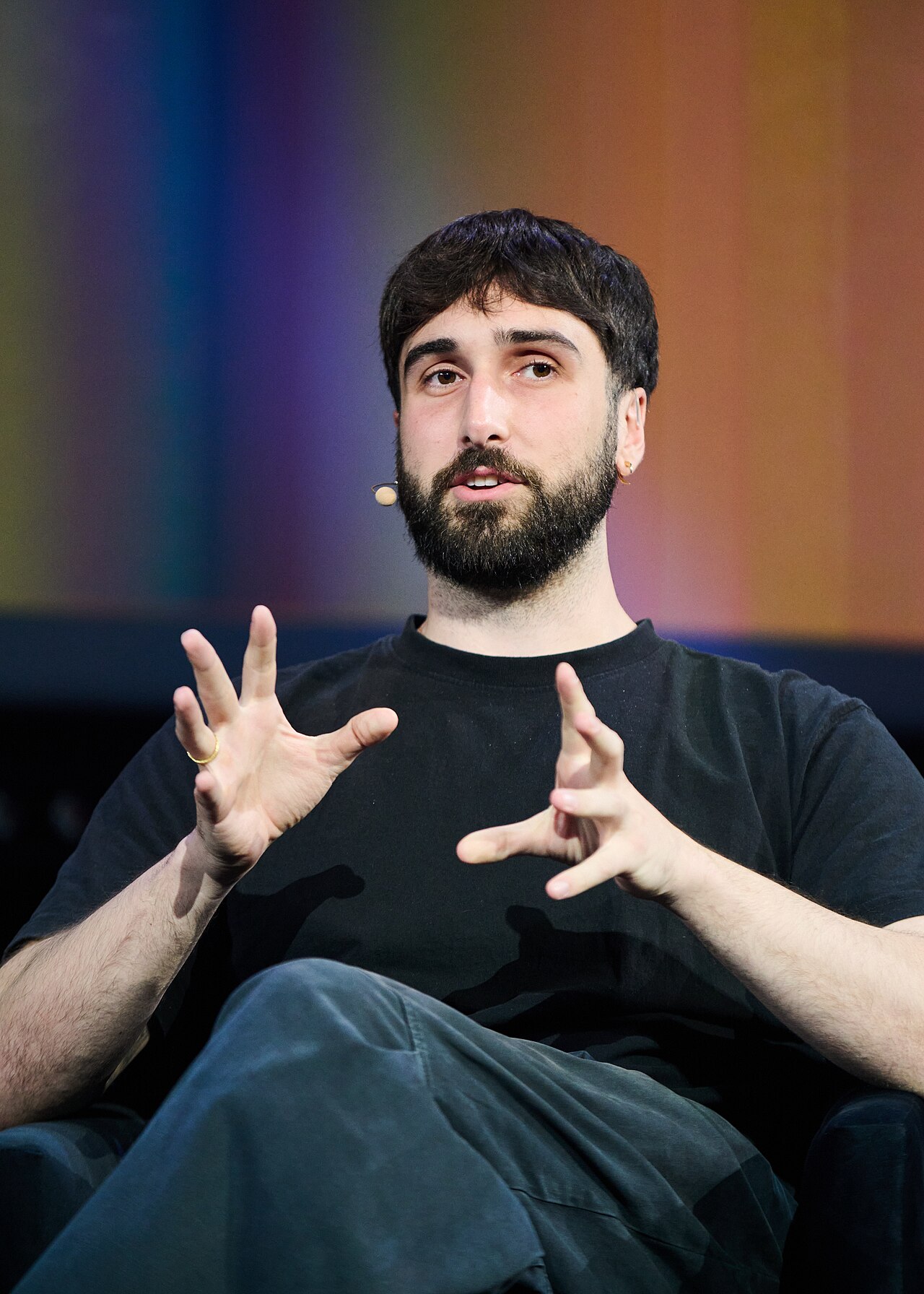 Cohere chief executive Aidan Gomez speaking on stage at a conference