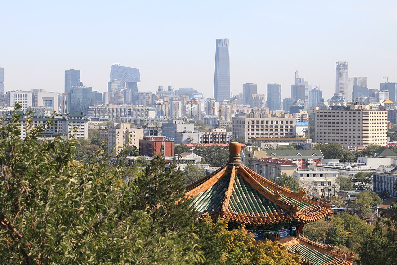 Skyline of Beijing's central business district seen over a pavilion roof in Jingshan Park
