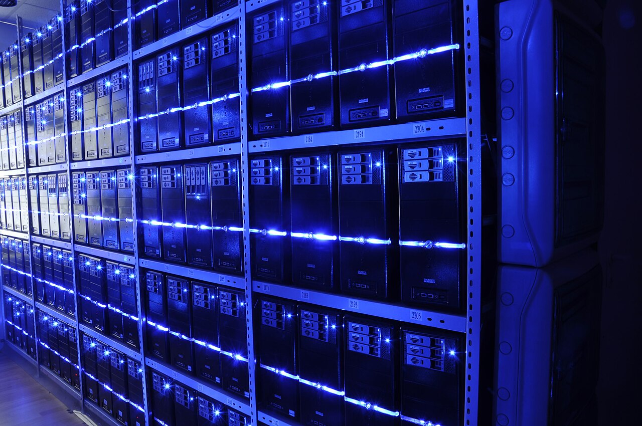 Rows of servers in a data center with blue indicator lights