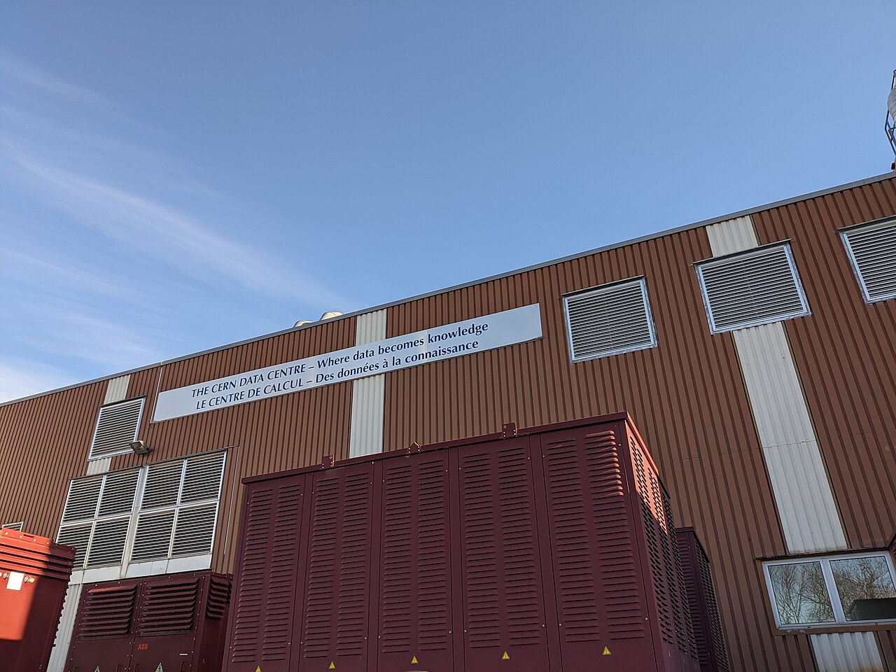 Exterior of a large data center building with rooftop cooling equipment