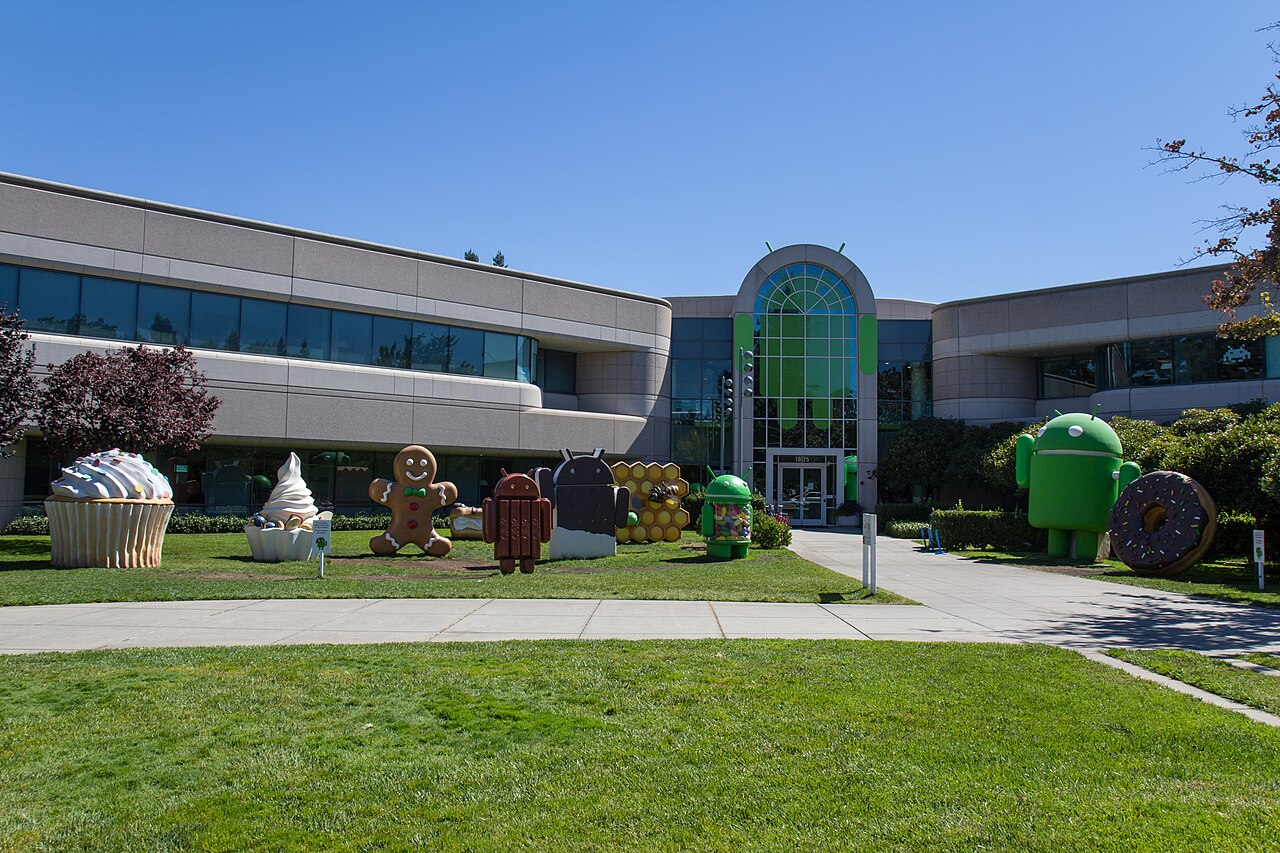 Android version-themed mascot statues on a lawn outside a Google building on its Mountain View campus
