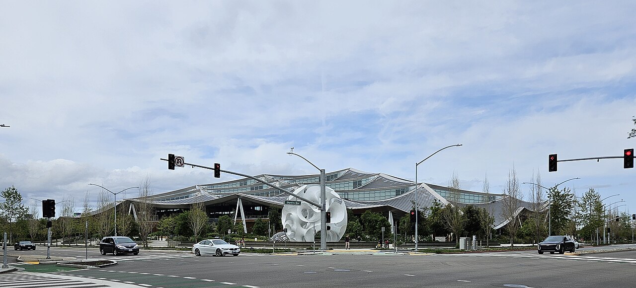Google's Gradient Canopy building in Mountain View, California, with a white sculpture in front of its wavy roofline