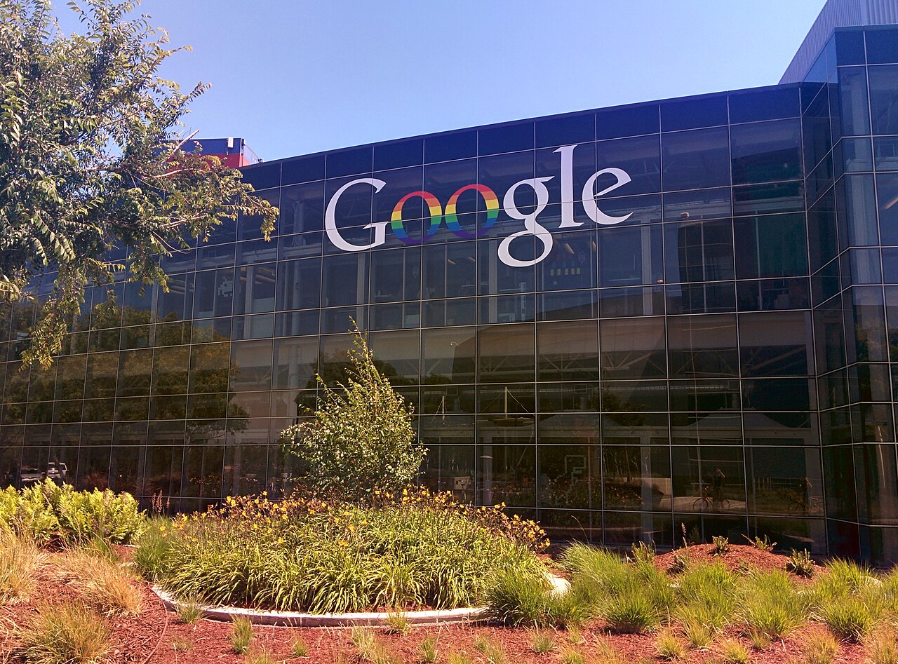 The Googleplex, Google's headquarters in Mountain View, California, with the Google logo displayed on a glass building facade