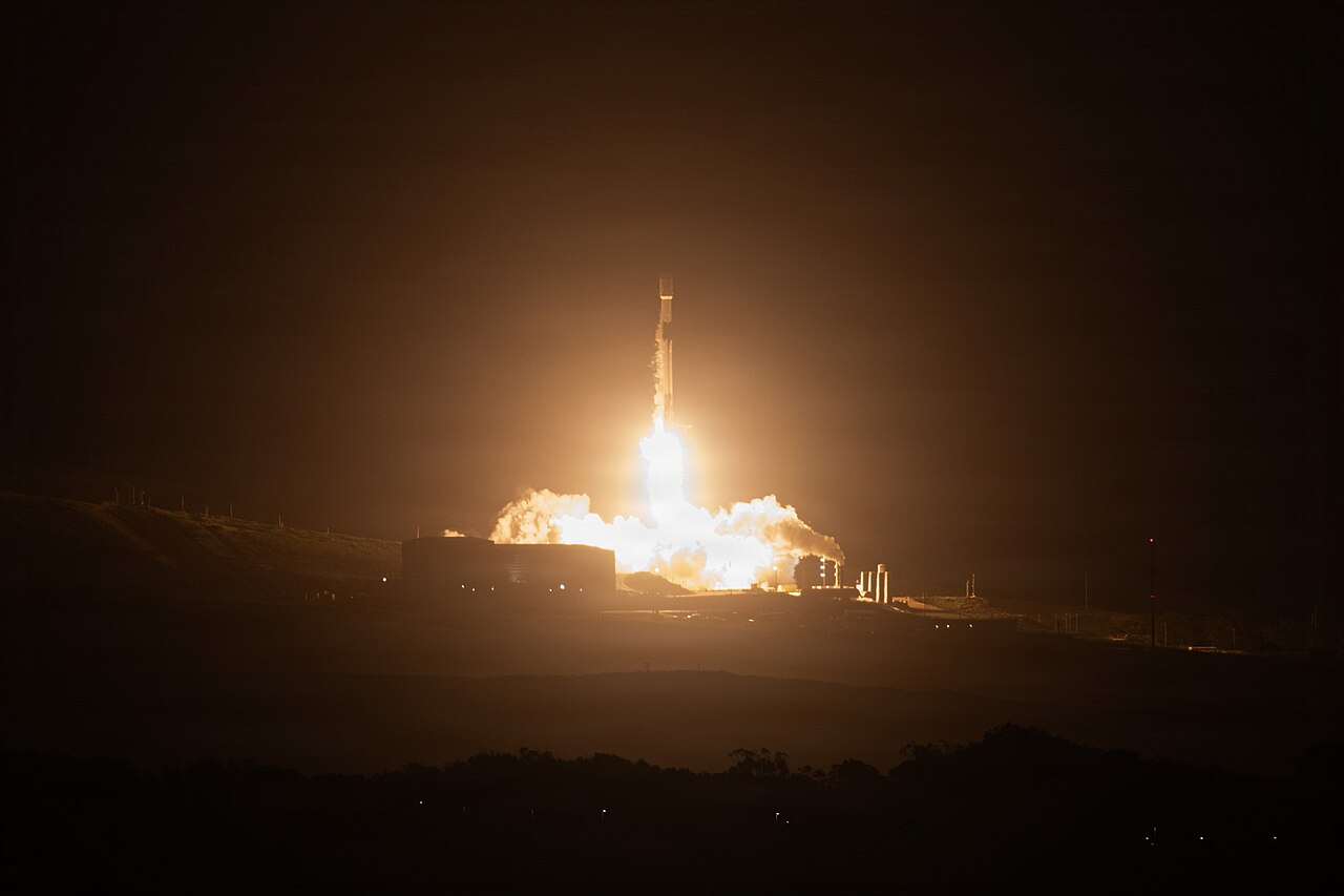 A SpaceX Falcon 9 rocket launching at night from Vandenberg Space Force Base