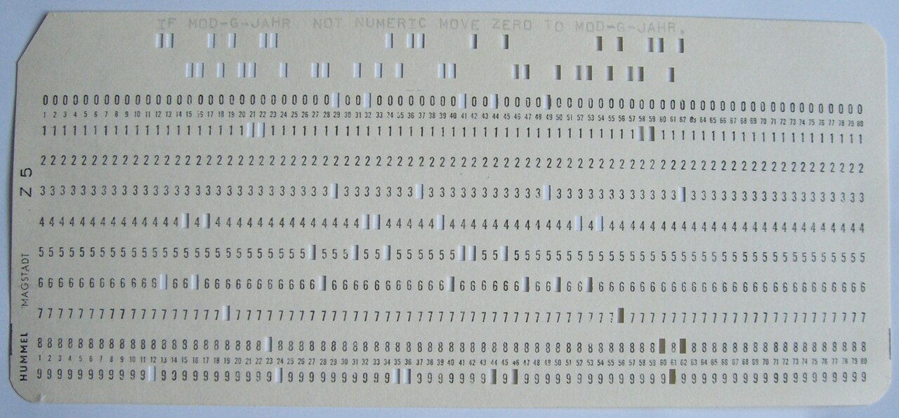 A punched card carrying a line of COBOL source text