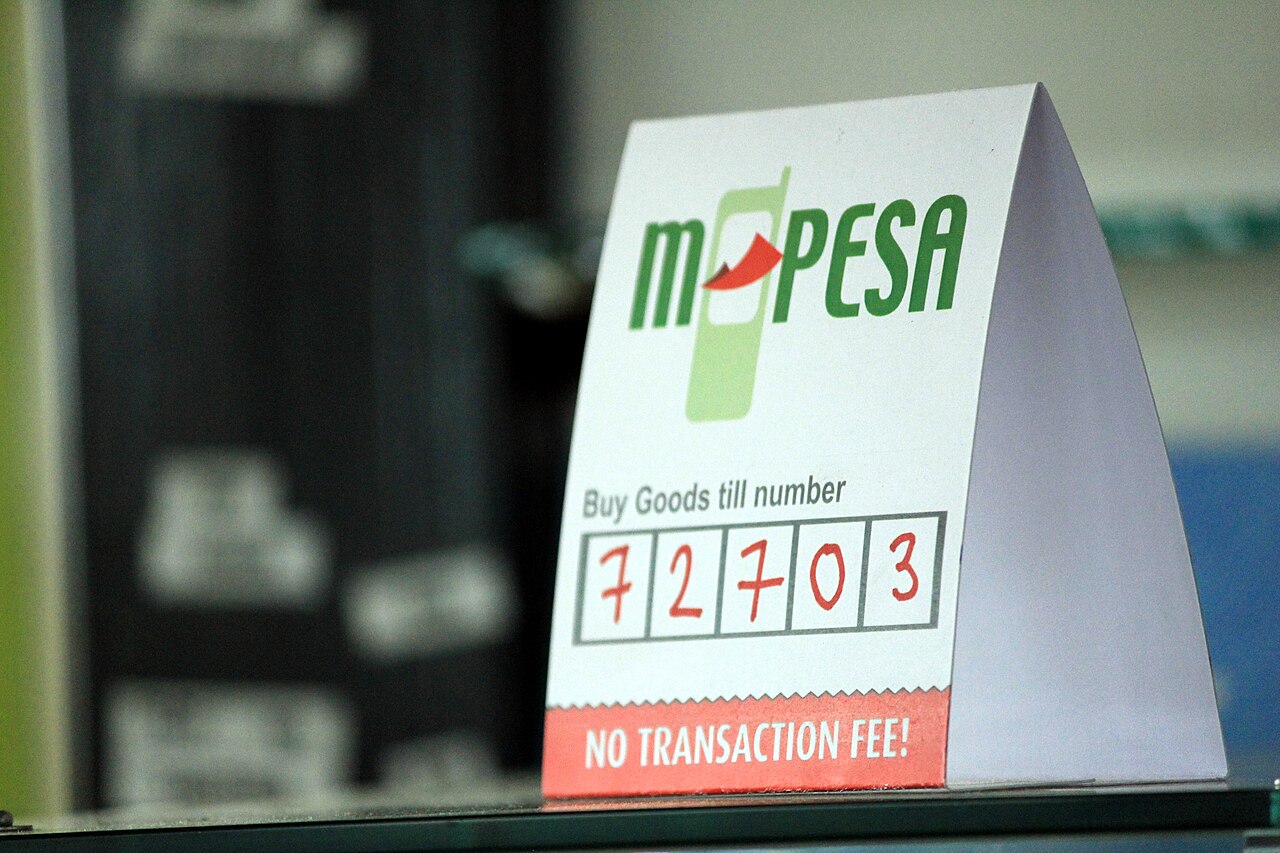 A mobile-money payment sign at a merchant, part of the shift to phone-based finance