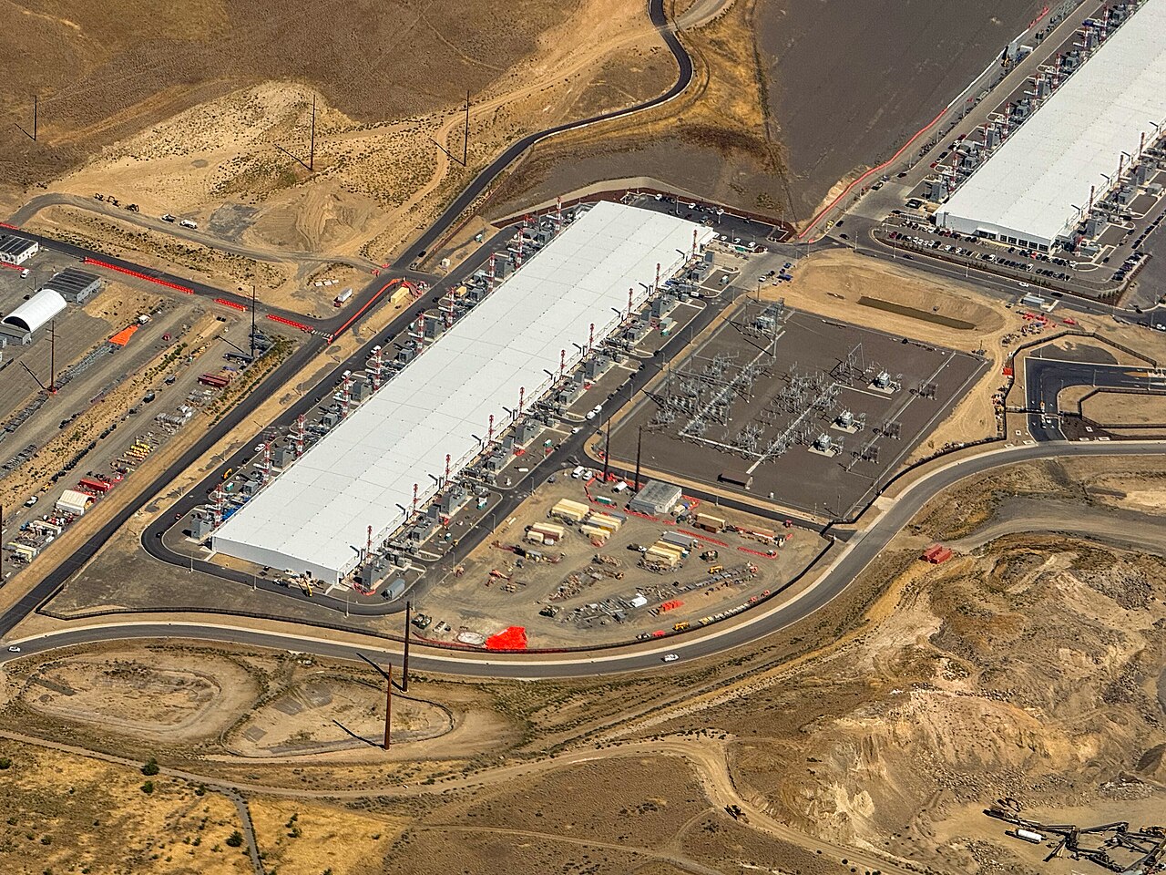 Aerial view of a large white-roofed Azure datacenter building and adjacent electrical substation near Wenatchee, Washington