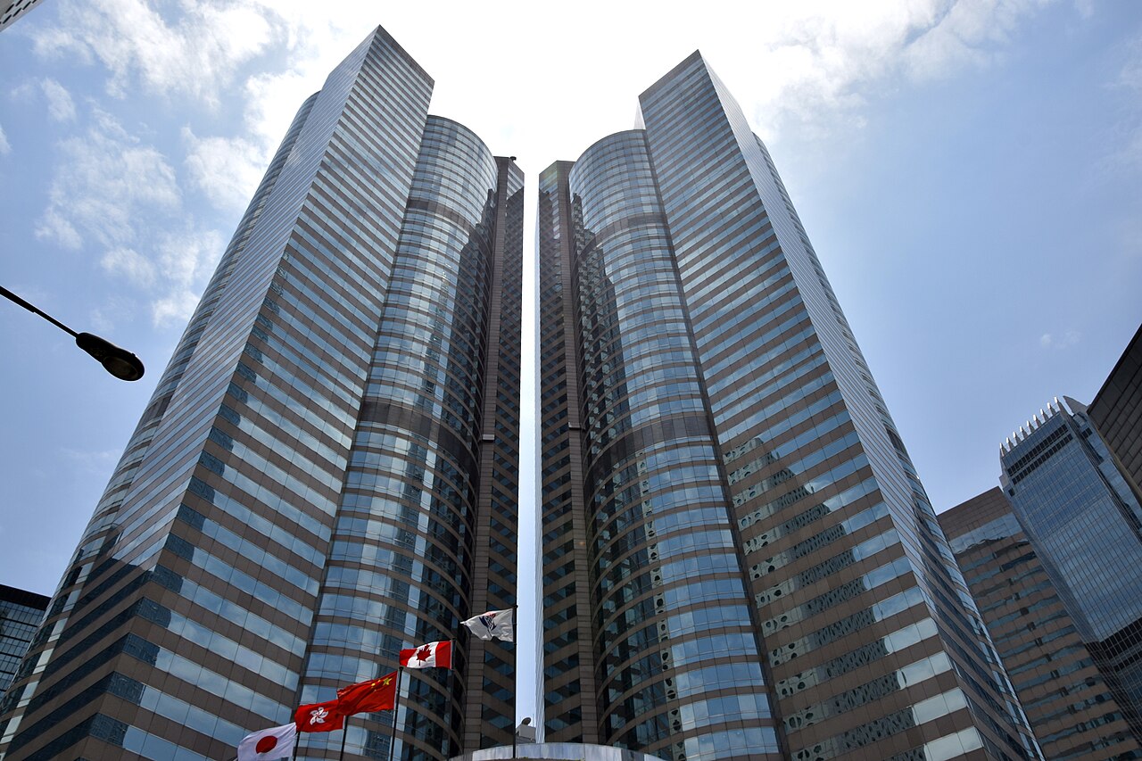 The Exchange Square towers that house the Hong Kong Stock Exchange, with national flags in front