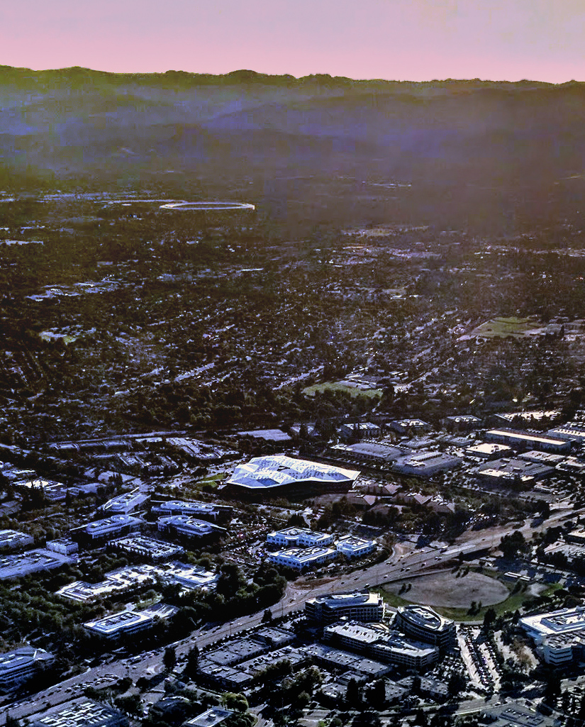 Aerial view of Nvidia's Santa Clara, California headquarters campus, with Apple Park visible in the distance