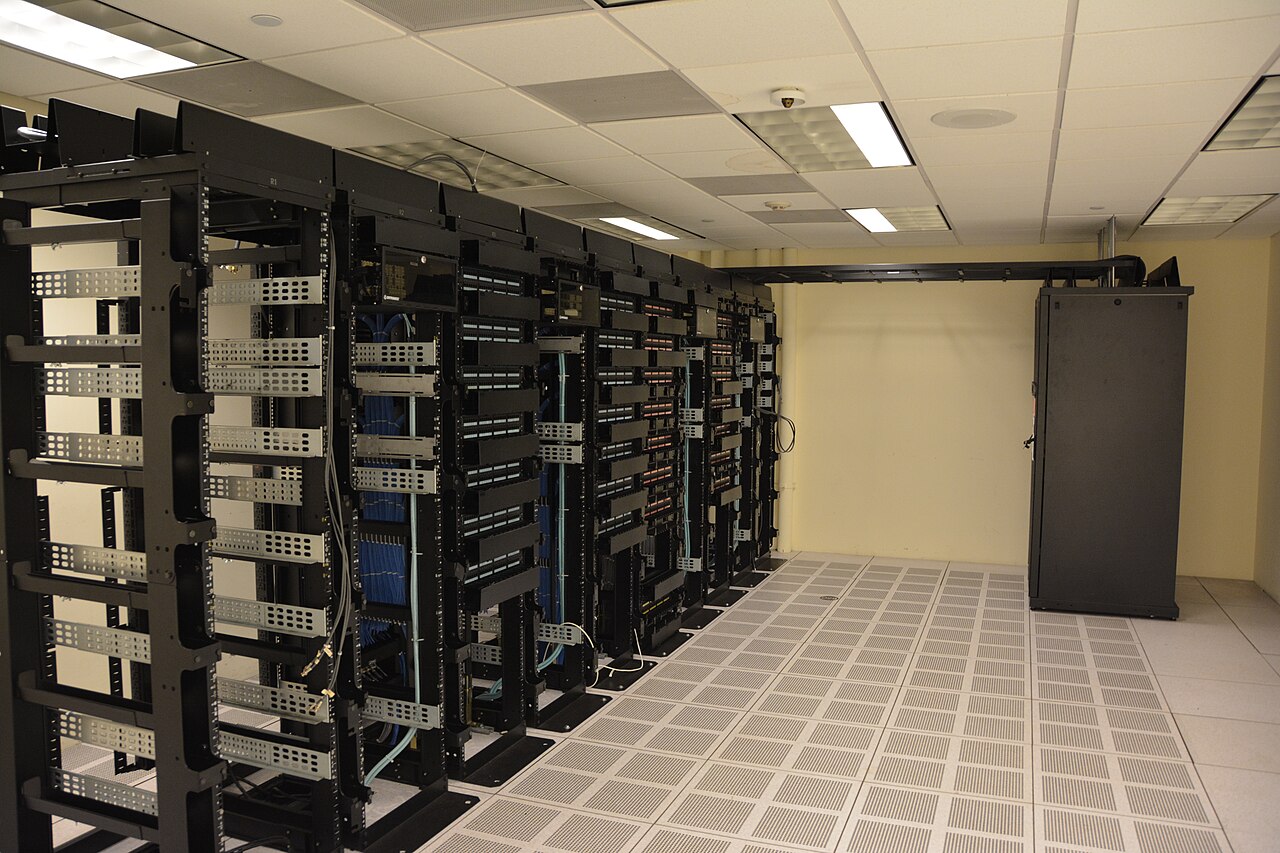 Rows of server racks inside a modern data center