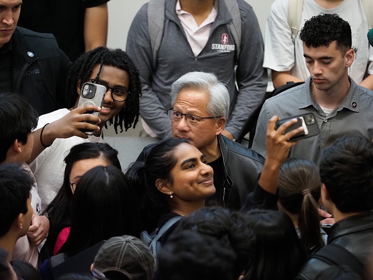 NVIDIA founder and CEO Jensen Huang surrounded by students at Stanford University in April 2026