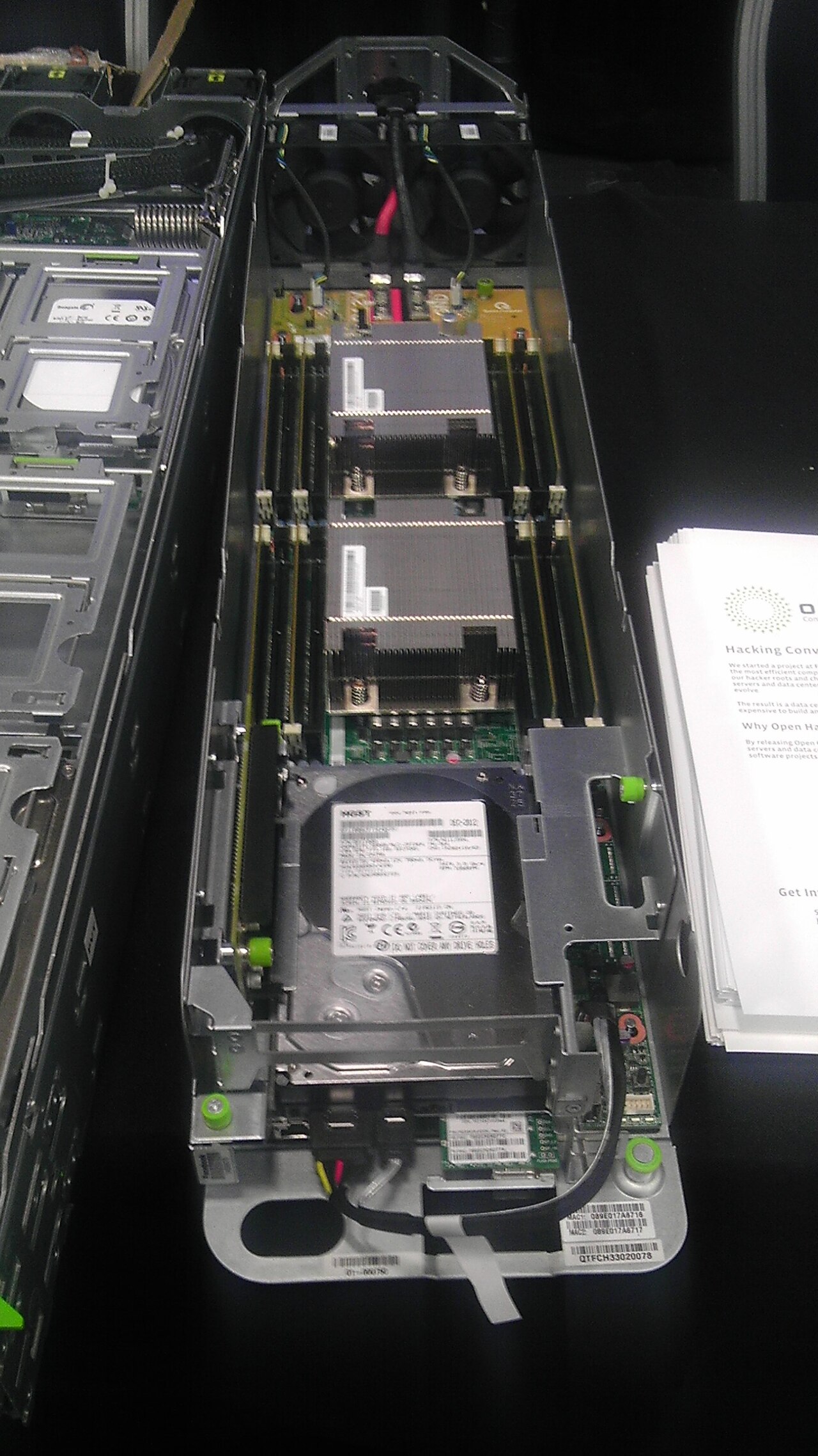 Open top view of an early Open Compute server sled with two heatsinks, memory slots and a hard drive