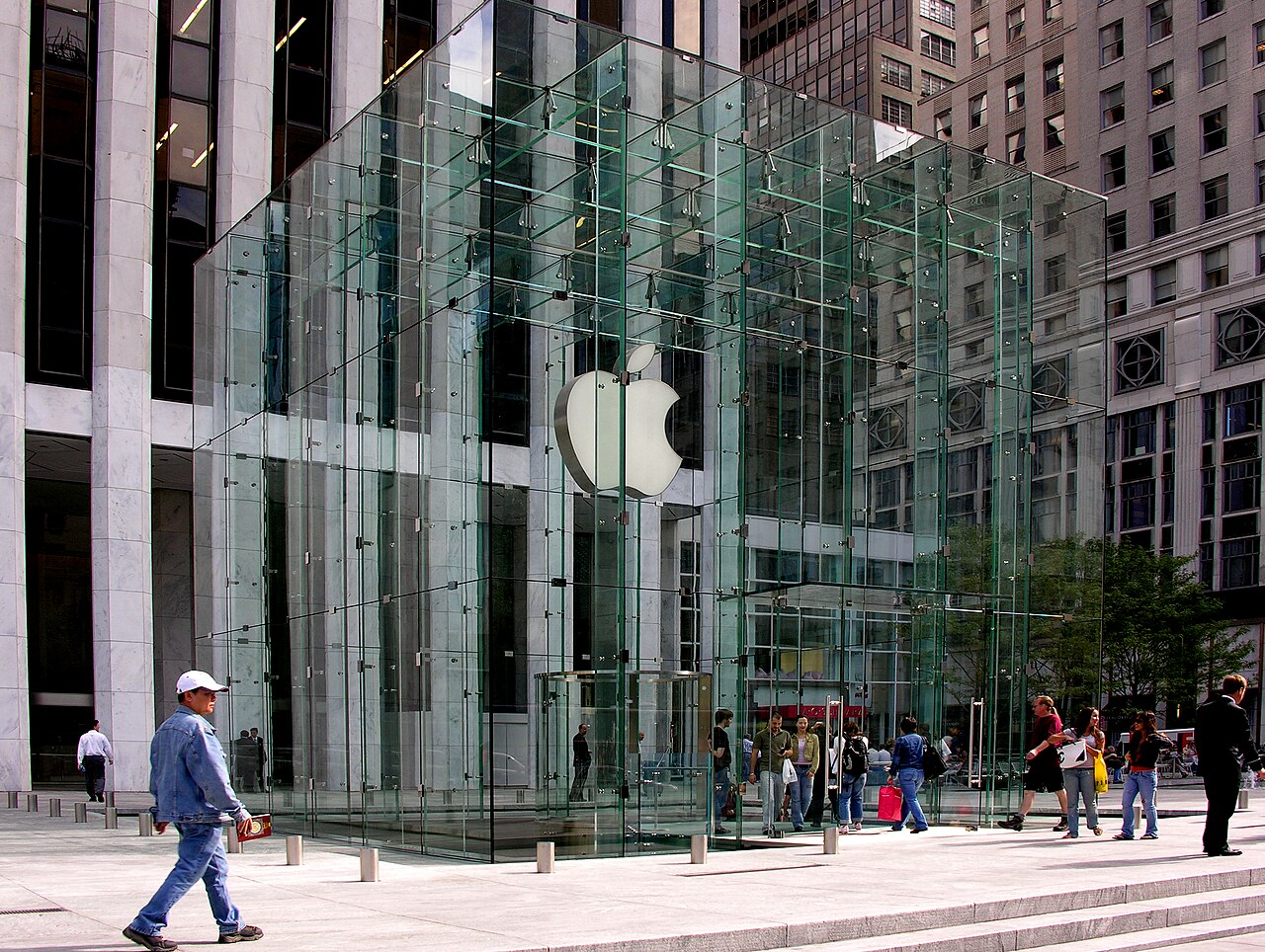 The Apple Fifth Avenue retail store, a glass cube structure with an illuminated Apple logo, in New York City
