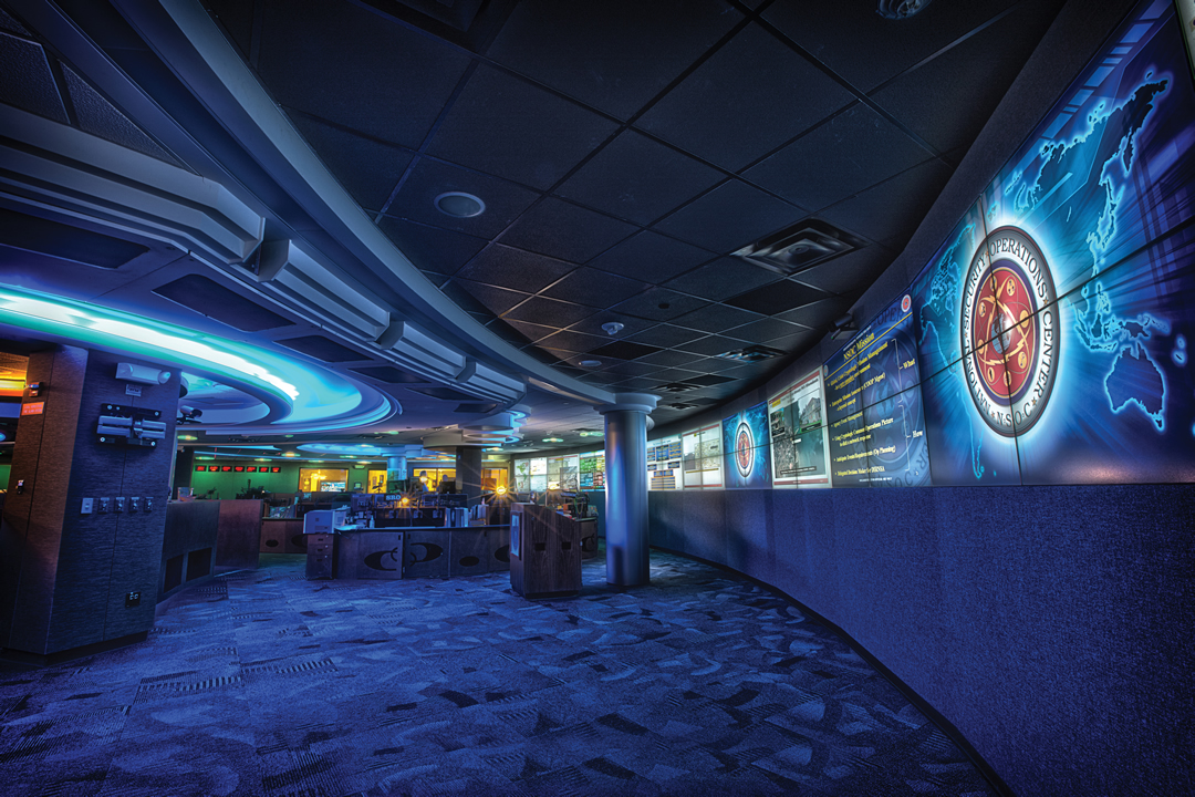Interior of a security operations center with wall-sized monitors and a curved video wall