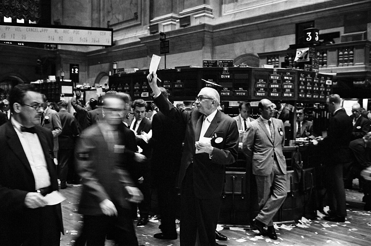 Traders on the floor of the New York Stock Exchange in a historical black and white photograph
