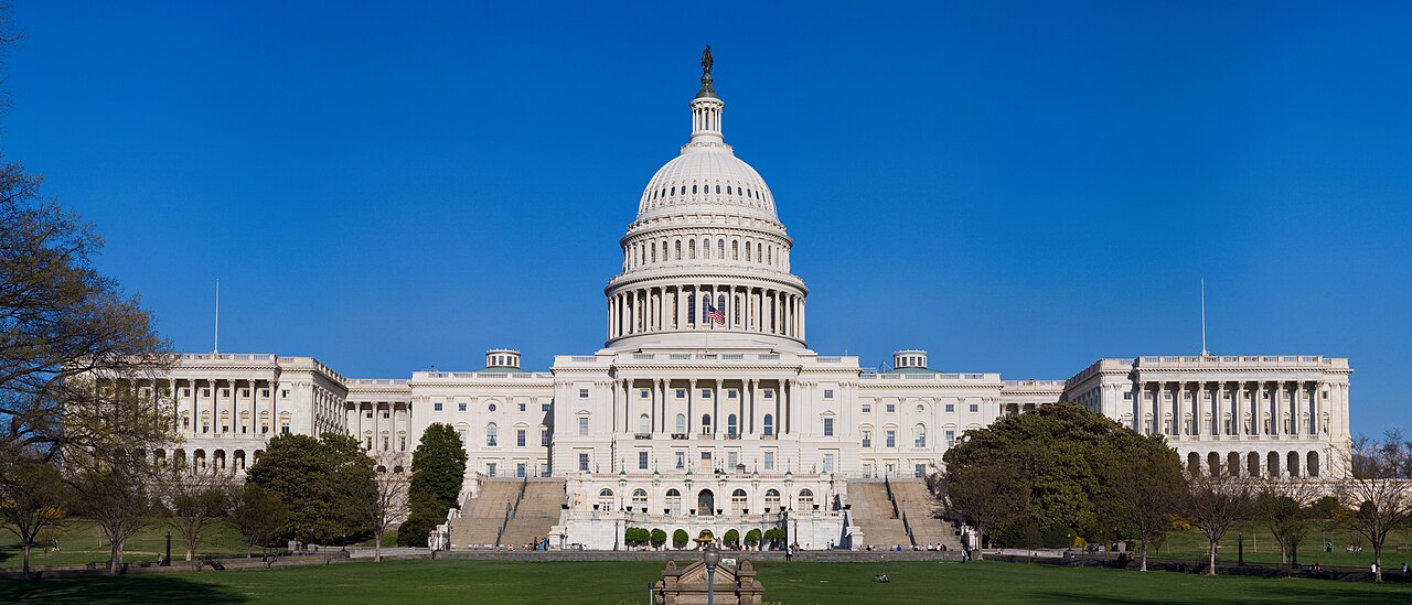 The United States Capitol building in Washington DC under a clear blue sky