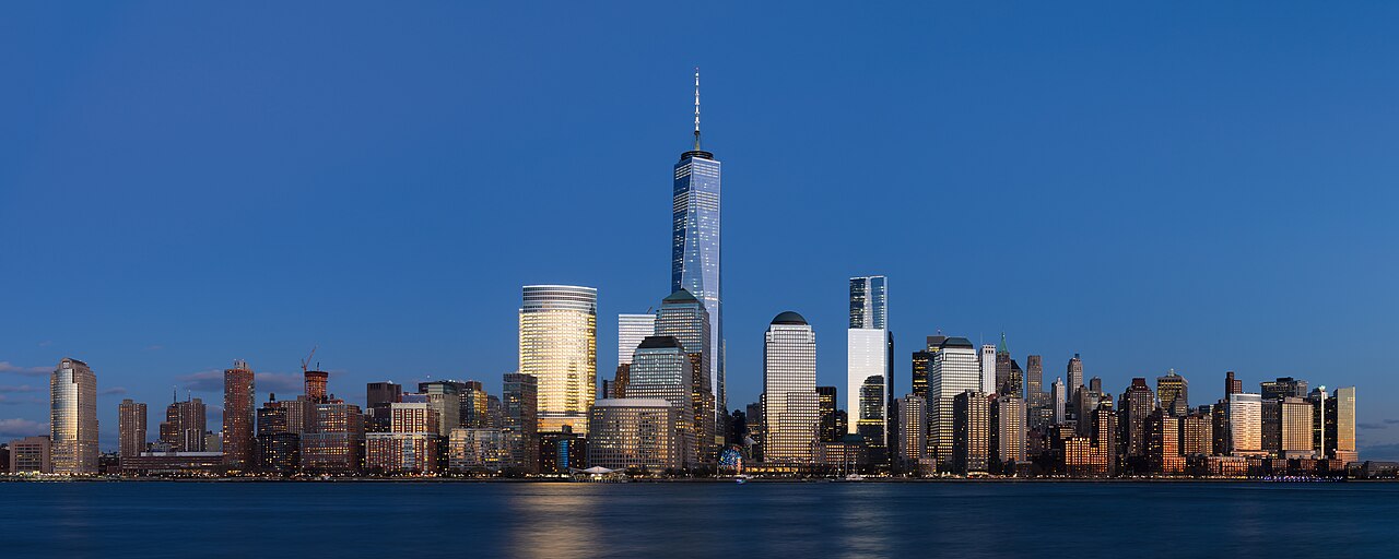 Panorama of the Lower Manhattan skyline at dusk across the Hudson River