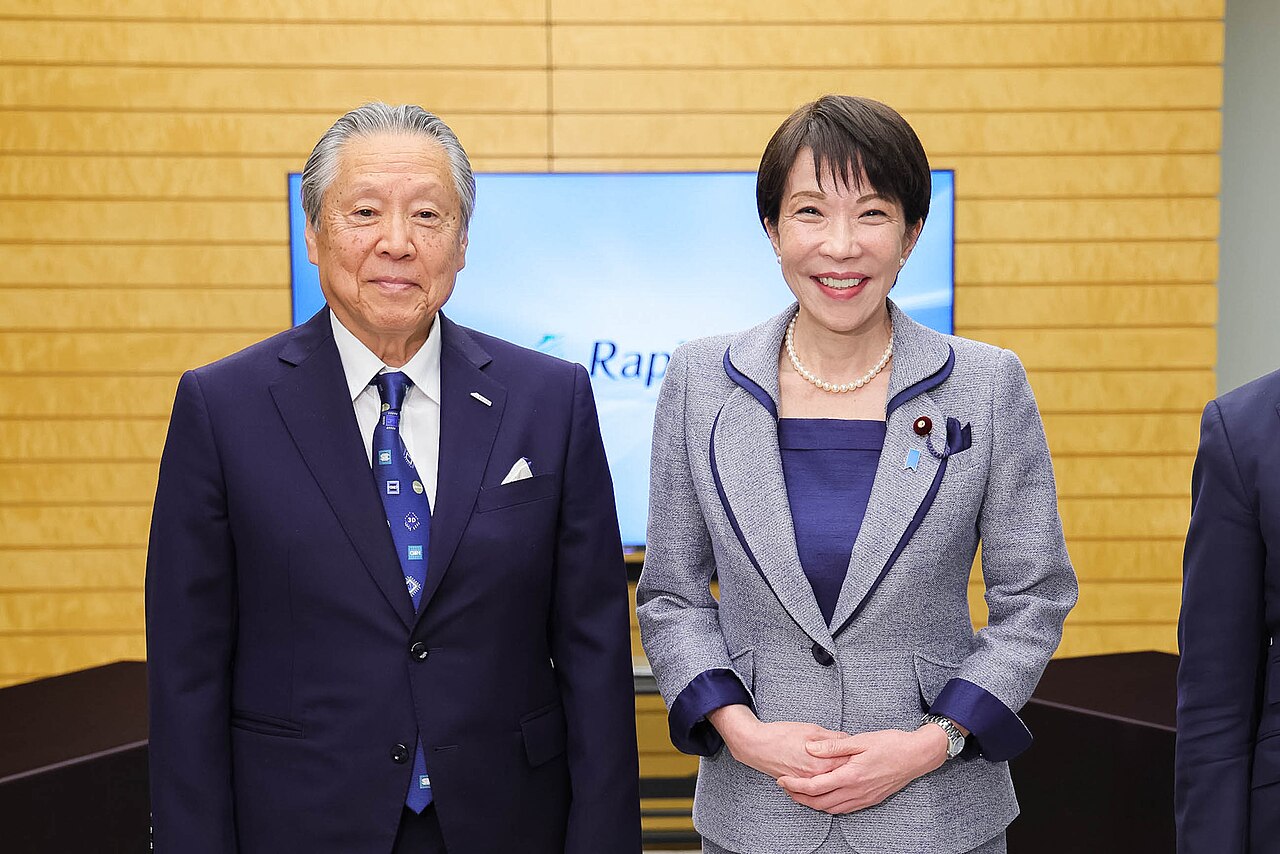 Rapidus chairman Tetsuro Higashi standing beside Japanese Prime Minister Sanae Takaichi