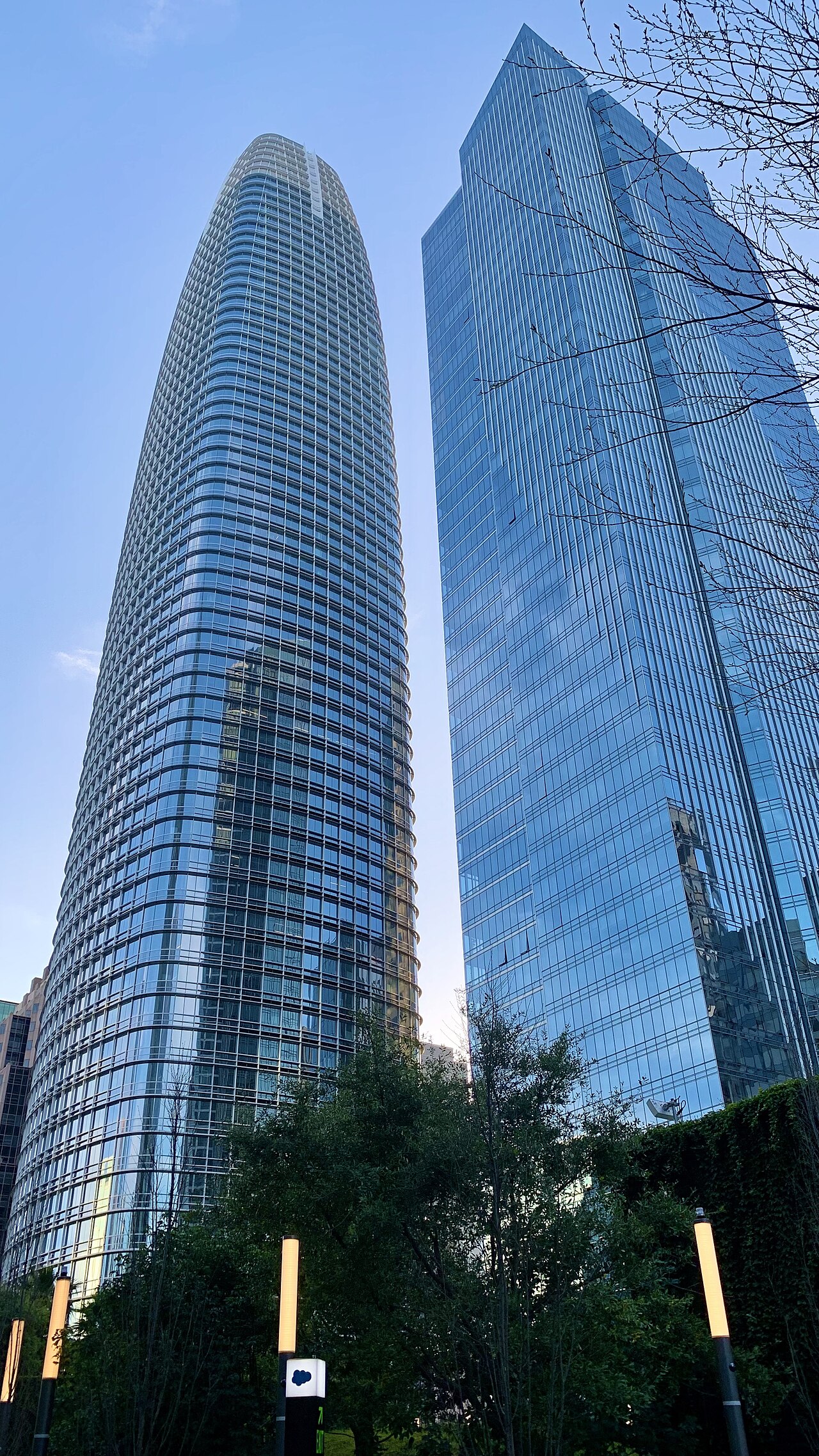 Salesforce Tower and Millennium Tower viewed from Salesforce Park in San Francisco, with a Salesforce cloud-logo sign visible at street level