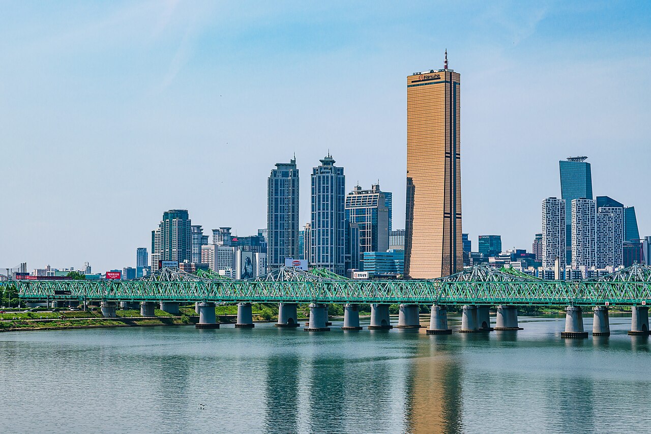 Skyscrapers of Yeouido, Seoul's financial district, behind the green Hangang Railway Bridge over the Han River