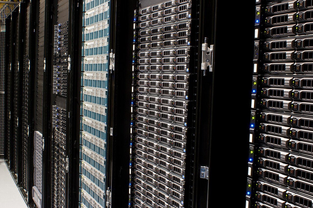 Rows of Dell server racks in a data center hall, the kind of large-scale compute the AI capex funds