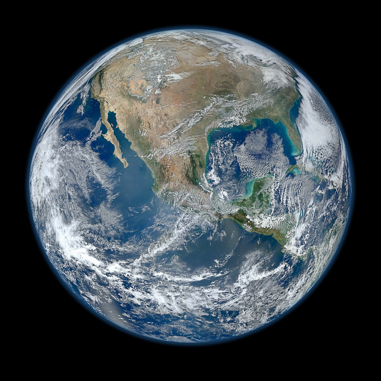 Earth viewed from space, showing North America under cloud cover against the black of space
