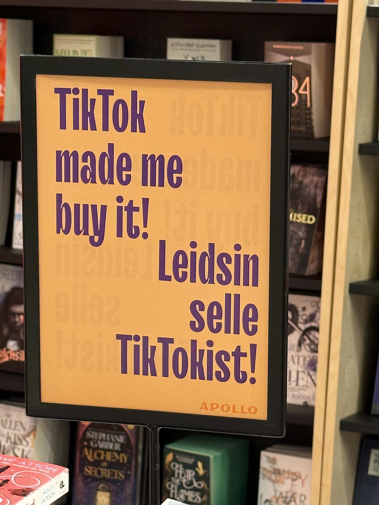 A bookstore shelf sign reading TikTok made me buy it, with Estonian text saying I found it on TikTok