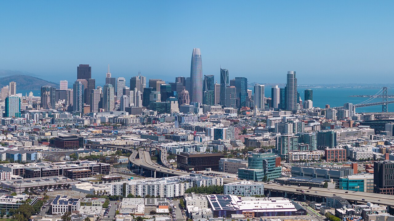 Aerial view of downtown San Francisco with Salesforce Tower and the Bay Bridge in the background