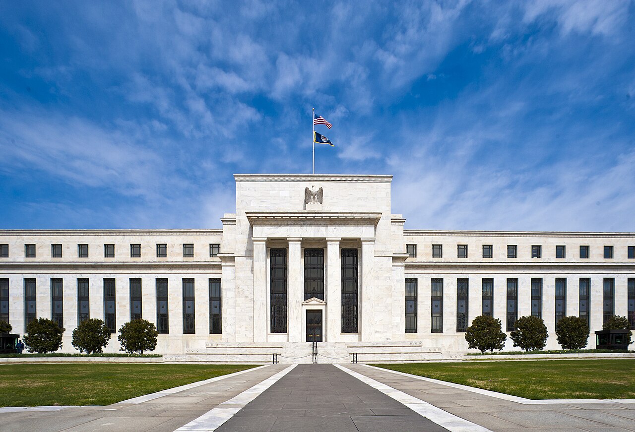 The Marriner S. Eccles Federal Reserve Board building in Washington, D.C., with the U.S. flag flying above the marble facade