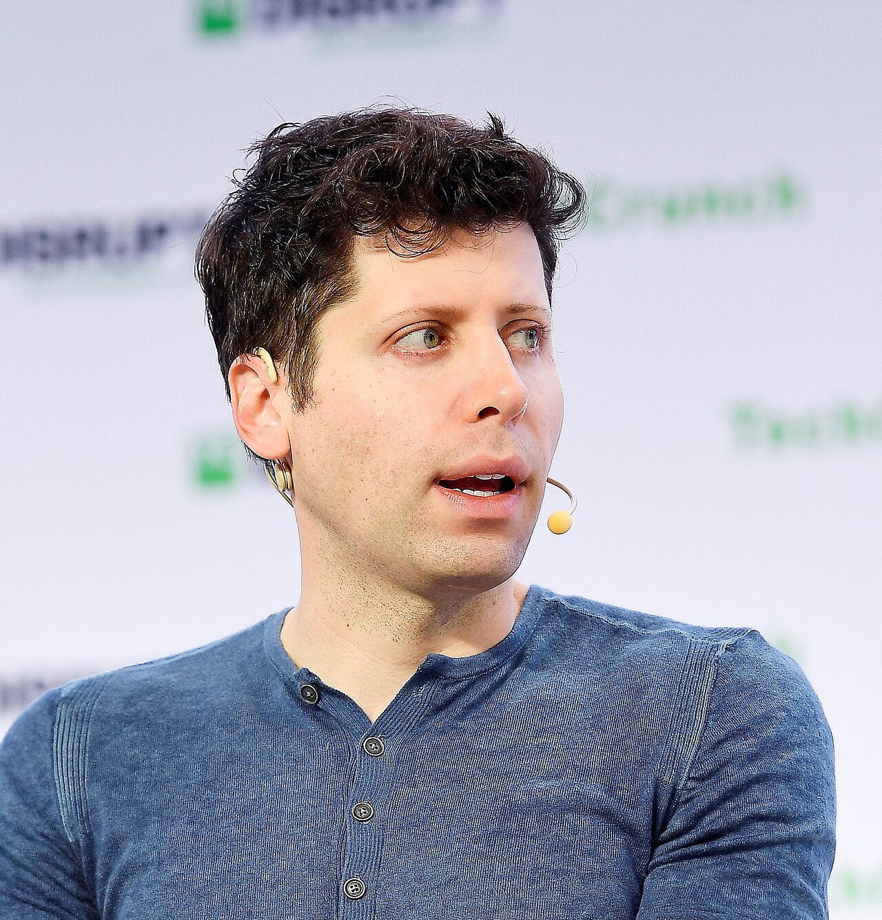 Portrait of Sam Altman, CEO of OpenAI, speaking on stage