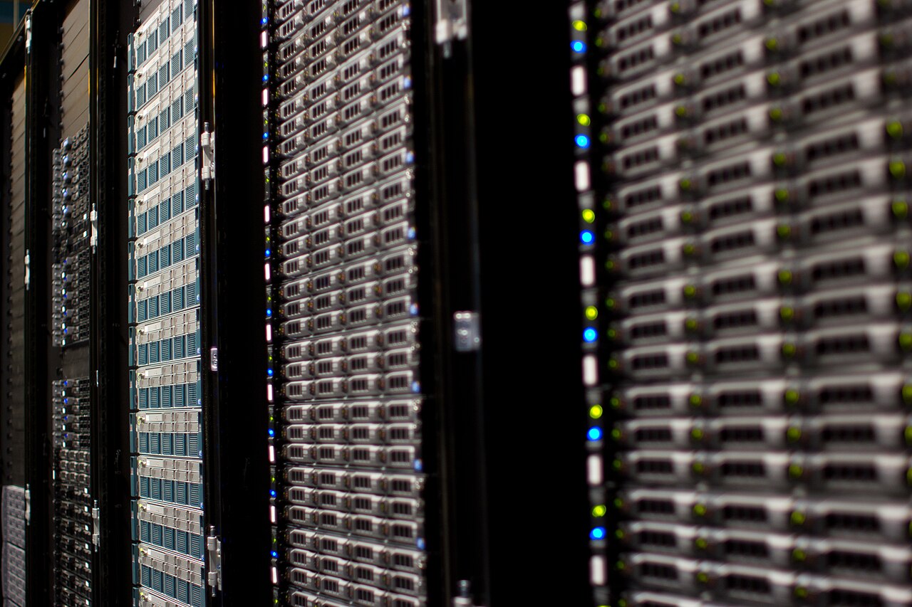 Rows of Wikimedia Foundation server racks with blue and green status lights
