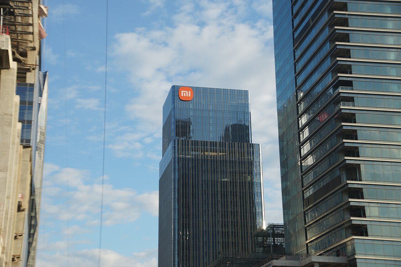 Xiaomi's Guangzhou office tower, a glass high-rise with an illuminated Mi logo near its top